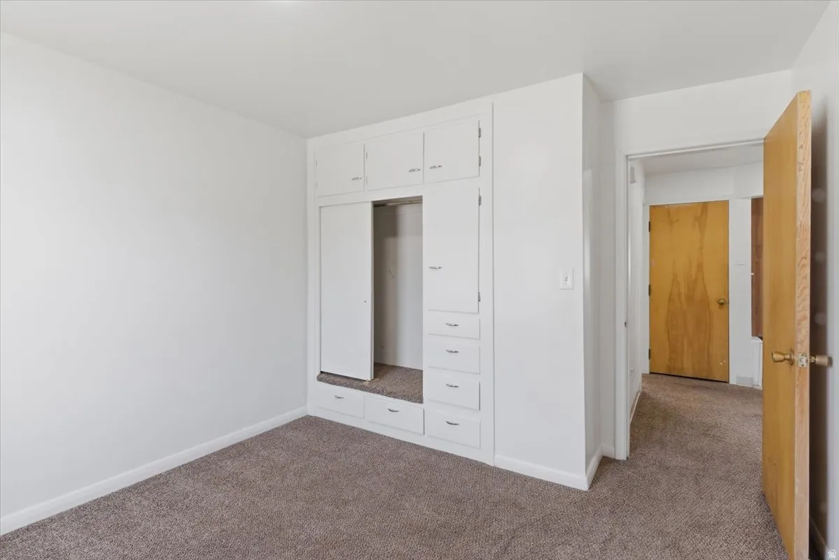 Integrated white cabinetry with upper storage and lower drawers