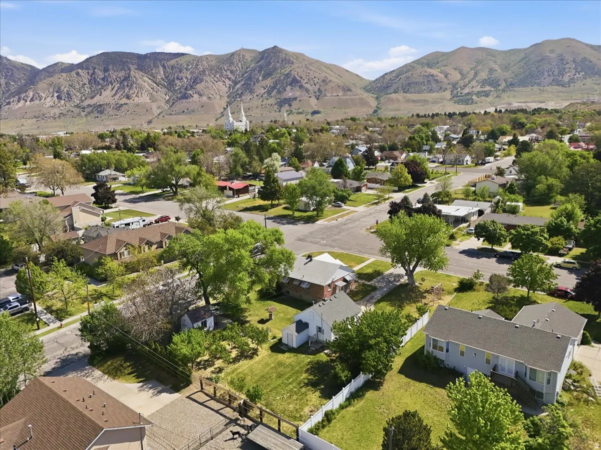 Residential neighborhood with mature trees situated at the base of mountains