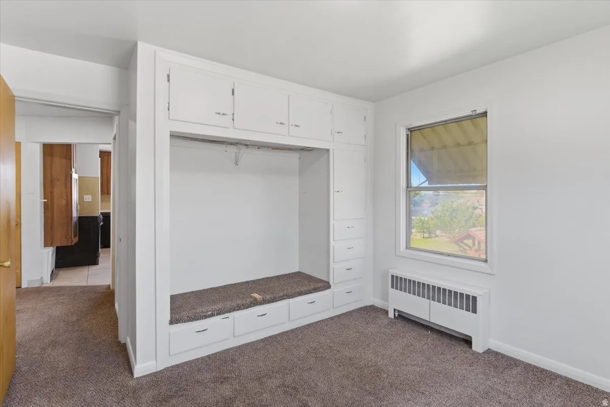 Built-in white cabinetry with a central recessed area and lower drawers