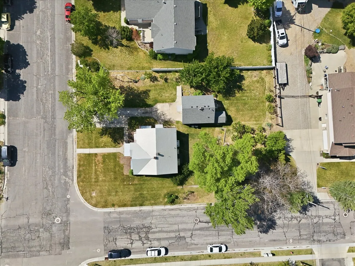 Aerial view of a residential property with a main house and a detached accessory structure