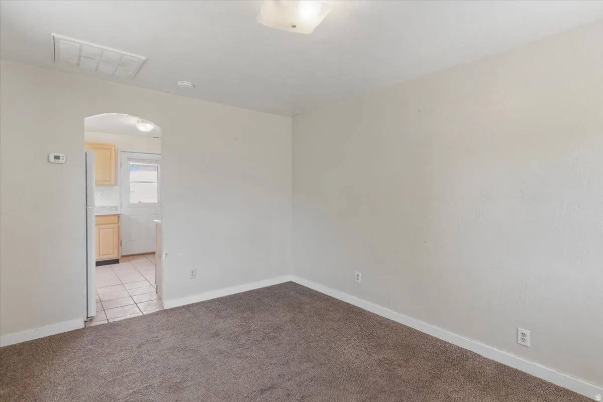 Carpeted room with light-colored walls and white trim