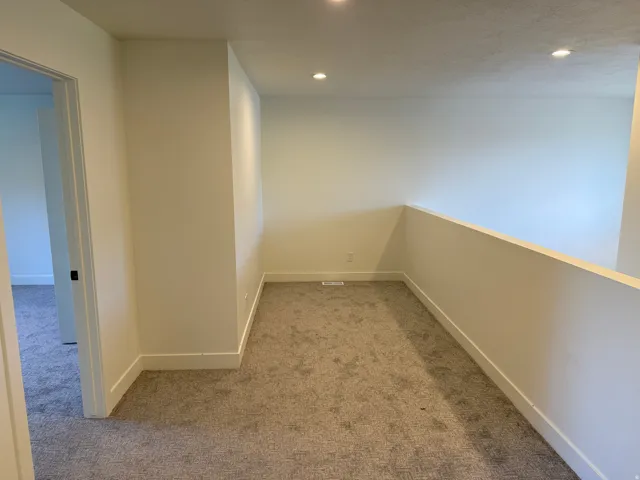 Loft space featuring recessed lighting, a neutral color palette, and carpeted flooring