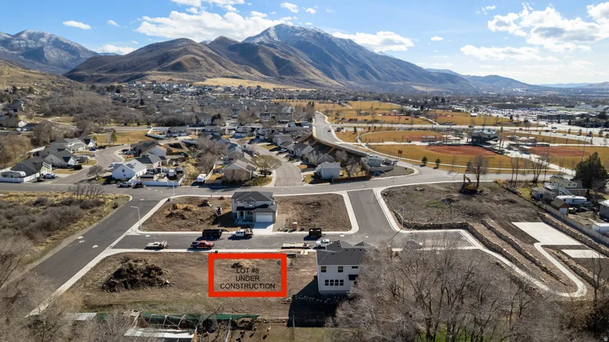 Level building lot with mountain backdrop, surrounded by developed residential areas and new construction