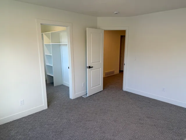 Neutral wall paint with textured carpet flooring