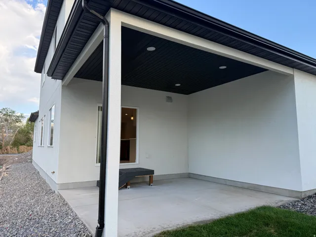 Covered patio with recessed lighting, concrete flooring, and an exterior window
