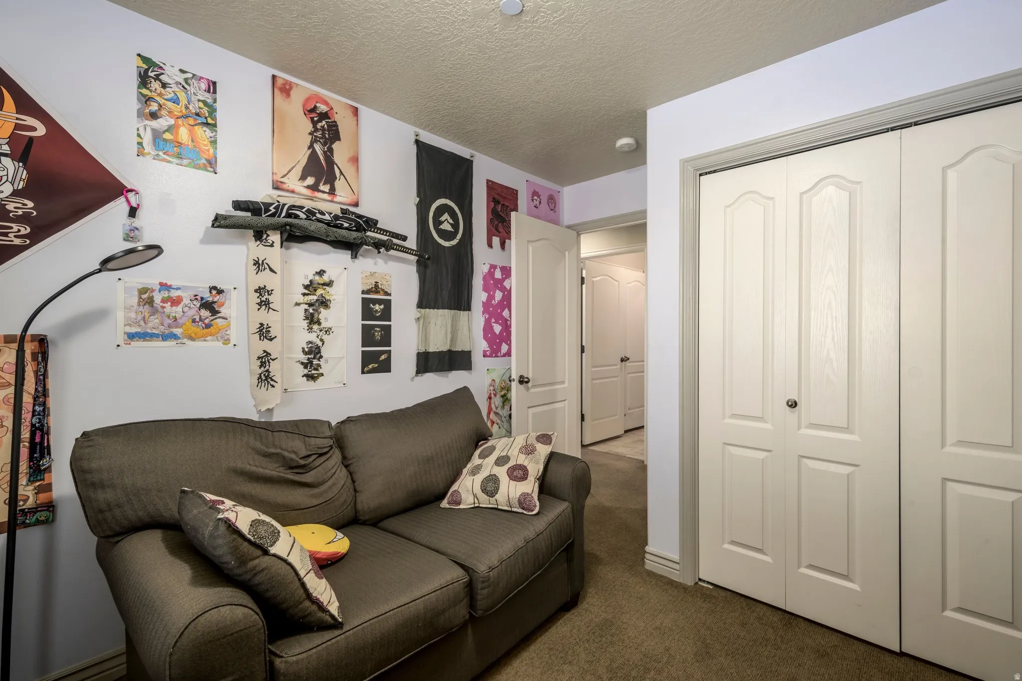 Interior room featuring neutral wall paint, textured ceiling, and carpeted flooring