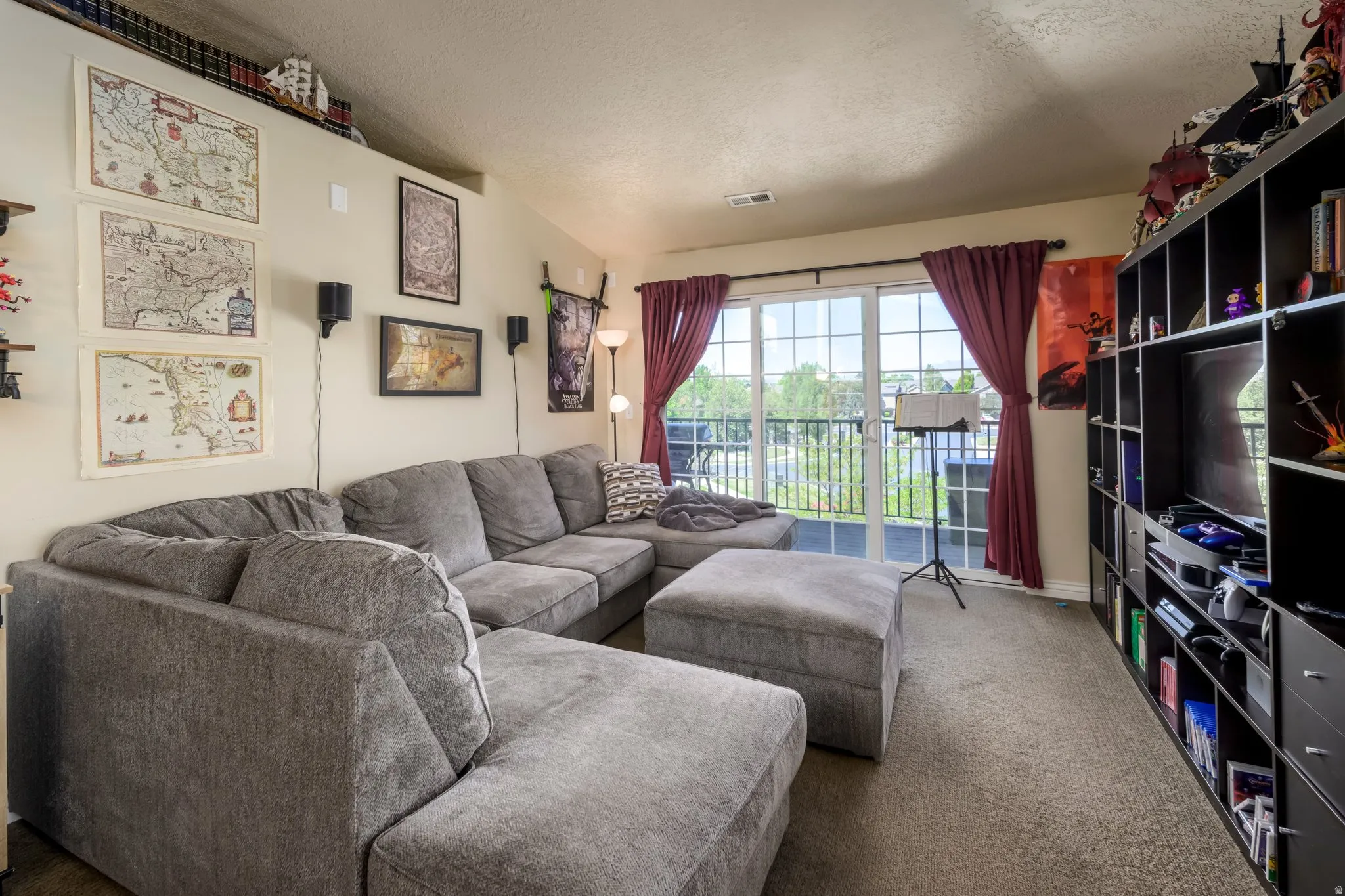 Living area featuring soft neutral carpeting and a vaulted ceiling