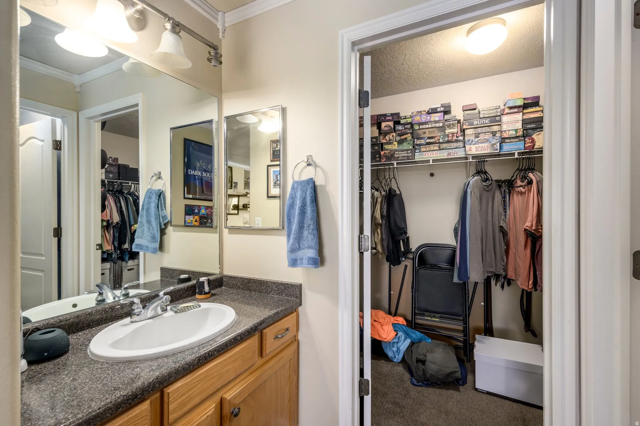 Vanity area featuring a single basin sink, speckled countertop, and wood-finish cabinetry