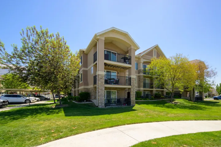 Multi-story building featuring stucco and stone veneer exterior