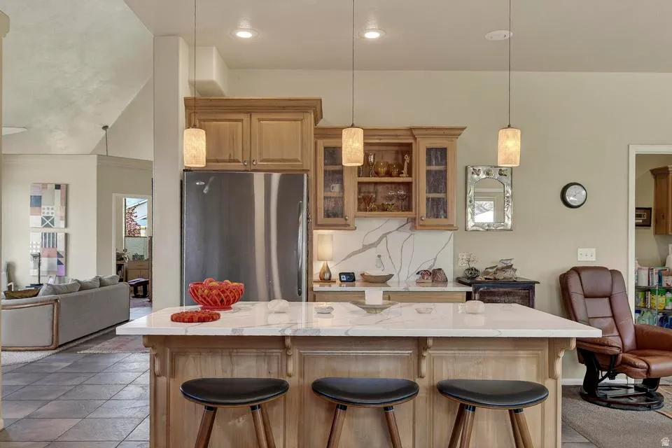 Kitchen island with a white countertop and wood-finish cabinetry