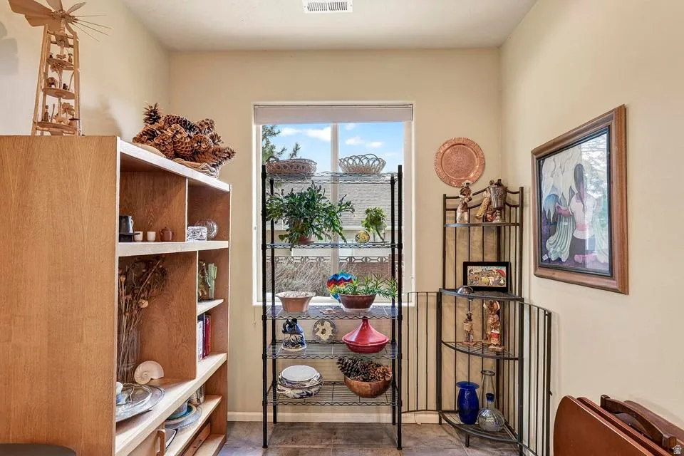 Interior room with light tan walls, a single pane window, and wood-finish flooring