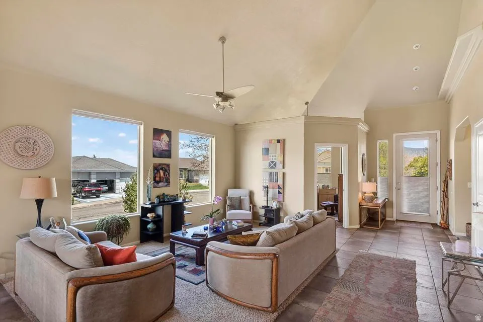 Open-concept living space featuring vaulted ceilings, recessed lighting, and large windows