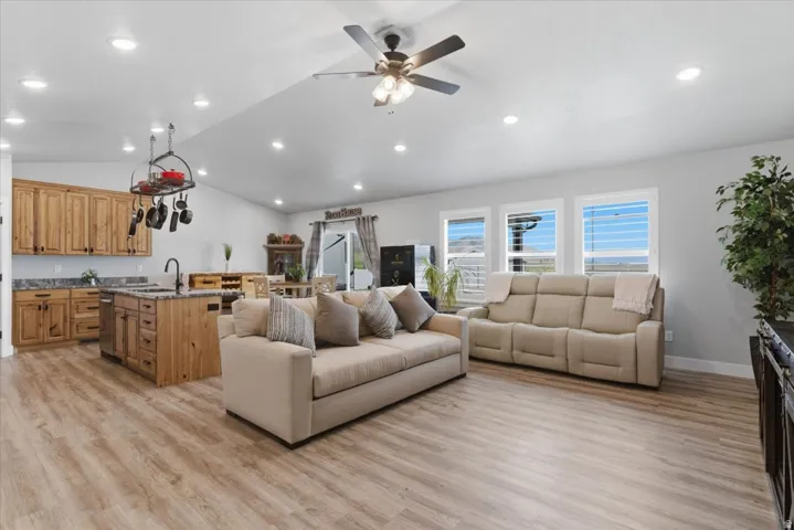 Open-concept living area featuring wood-finish flooring and recessed lighting