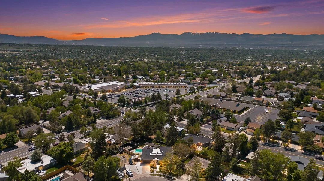 Expansive aerial perspective showcasing a residential neighborhood with distant mountains
