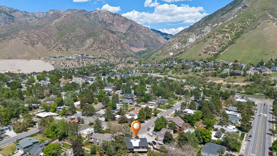 Aerial perspective showcasing a residential area amidst mountainous terrain