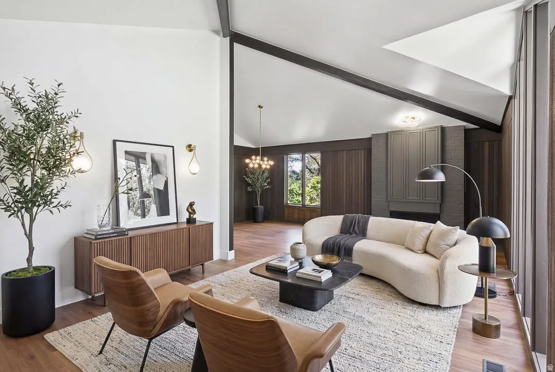 Vaulted ceilings with exposed beams complement the wood-finish flooring