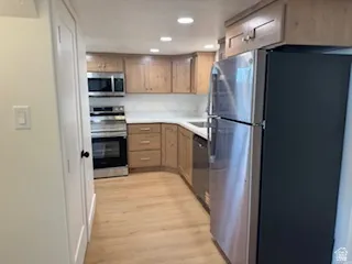 Kitchen featuring wood-finish flooring, recessed lighting, and light wood cabinetry