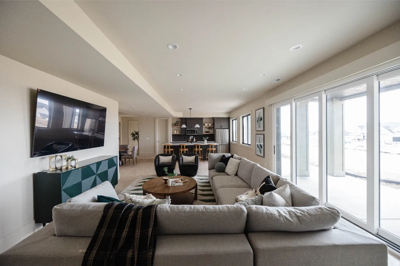 Open-concept living area with a contemporary kitchen visible