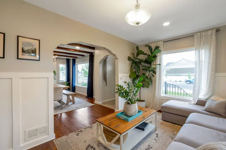 Living area featuring a large window, recessed lighting, and wood-finish flooring