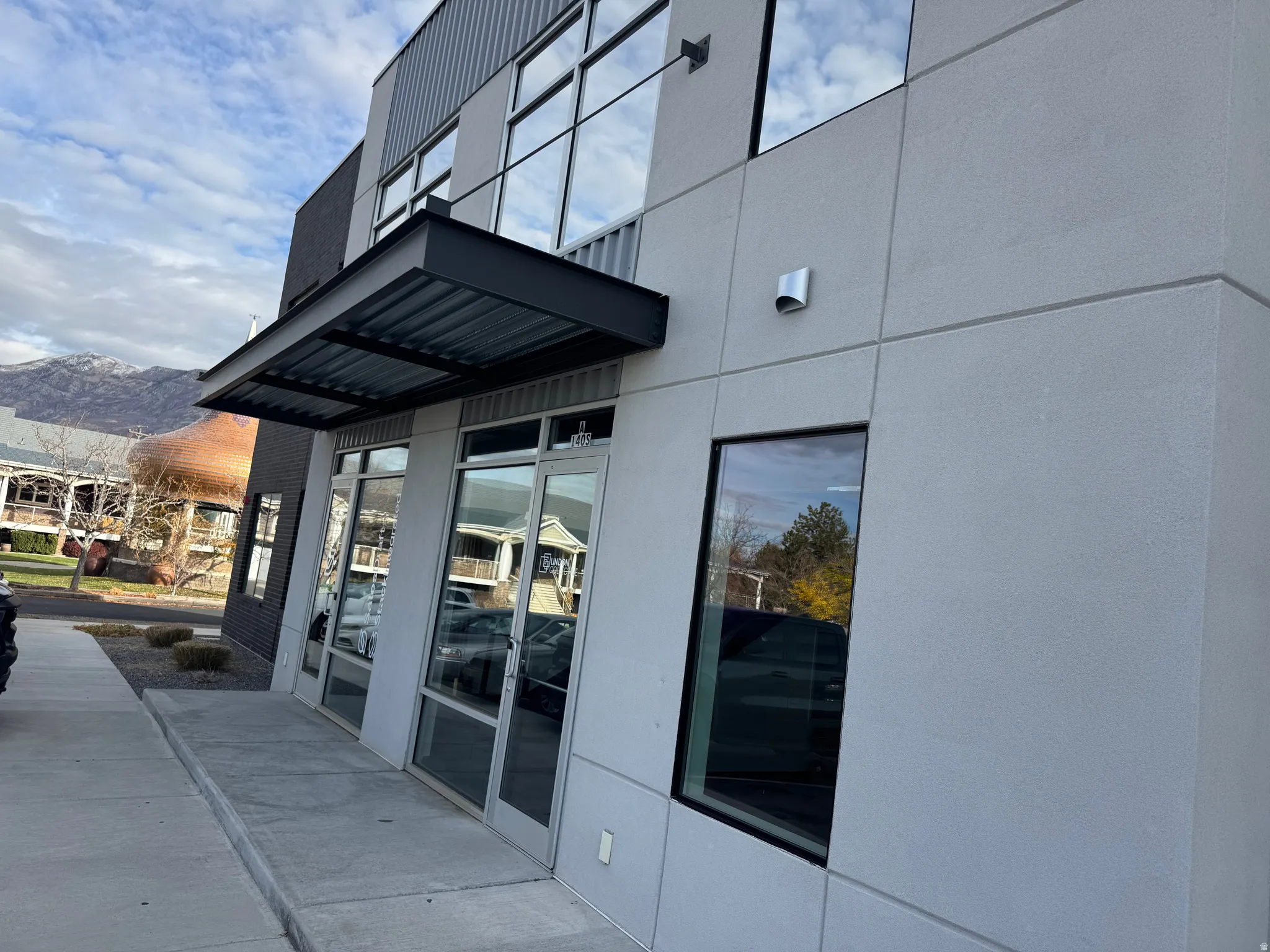 Modern commercial building featuring a corrugated metal awning