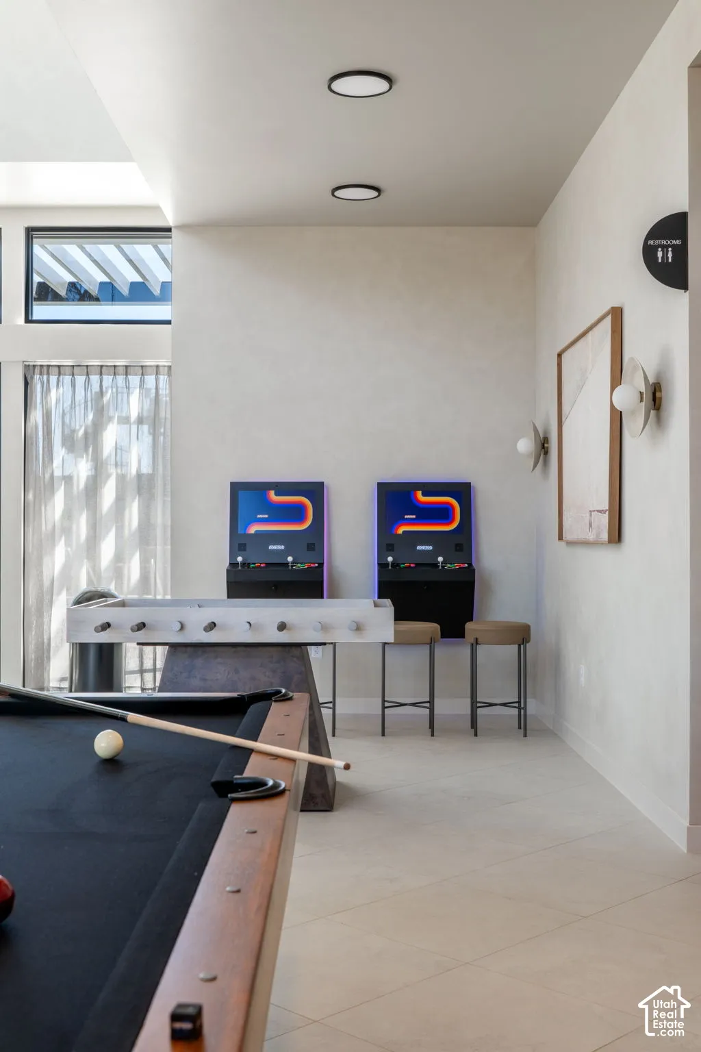 Recreation room featuring a pool table, foosball table, and arcade games