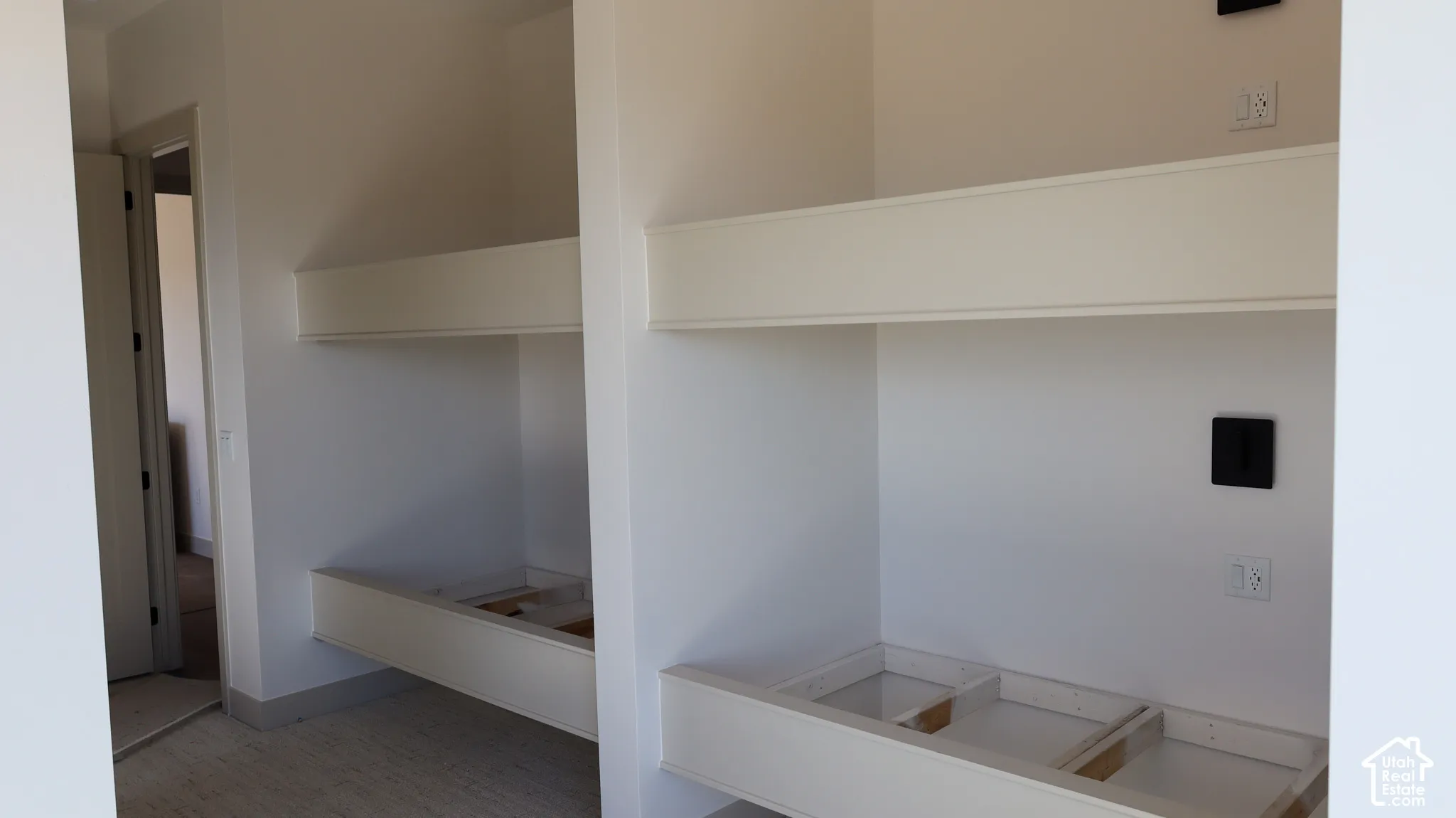 Built-in bunk bed structures with integrated wall outlets and light switches