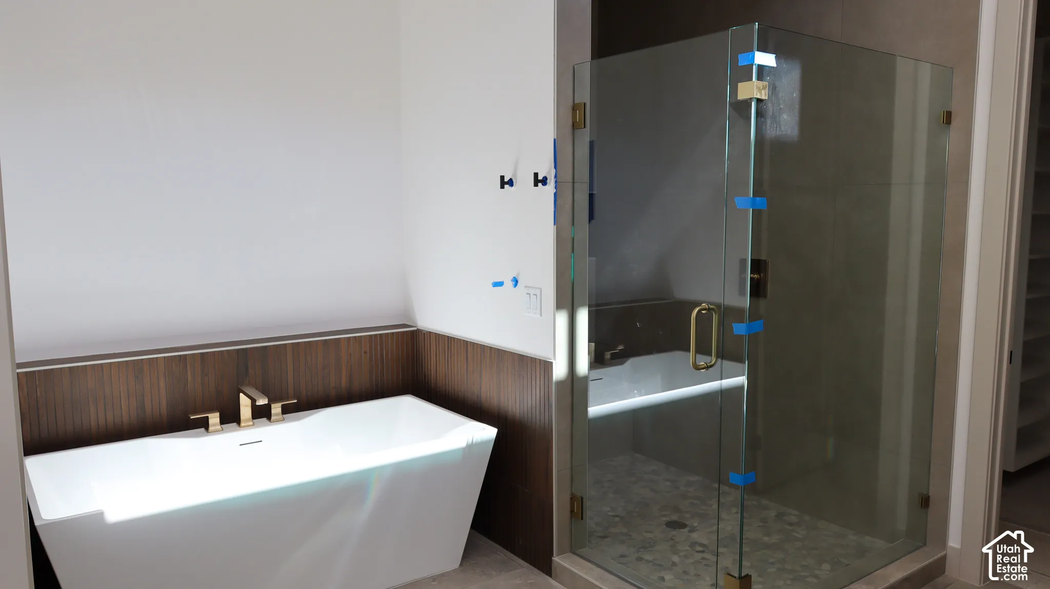 Freestanding soaking tub with gold-finish fixtures