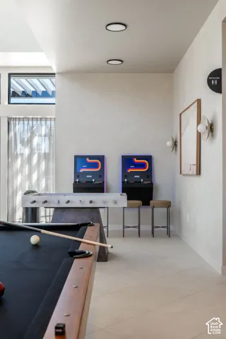 Recreation room featuring a pool table, foosball table, and arcade games