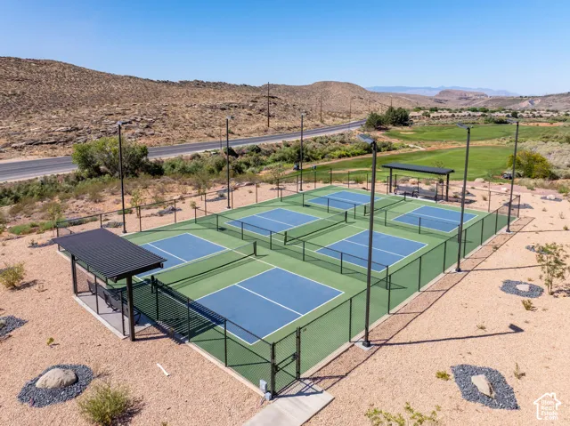 Multiple pickleball courts featuring green and blue surfacing