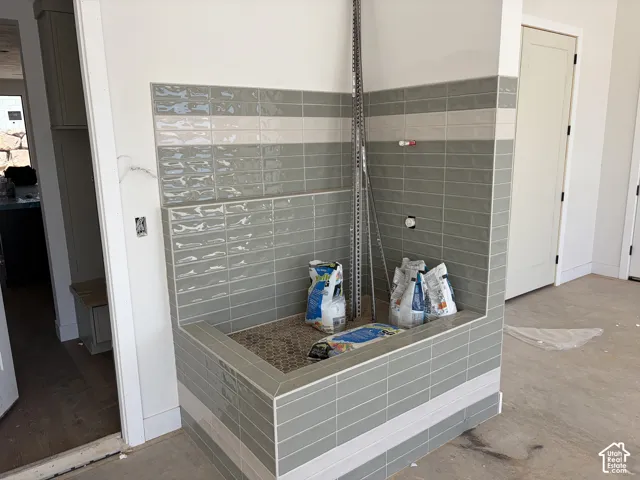 Built-in tiled utility basin featuring a textured floor and two-tone subway tile surround