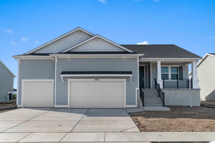 Contemporary residential exterior featuring light blue siding with white trim