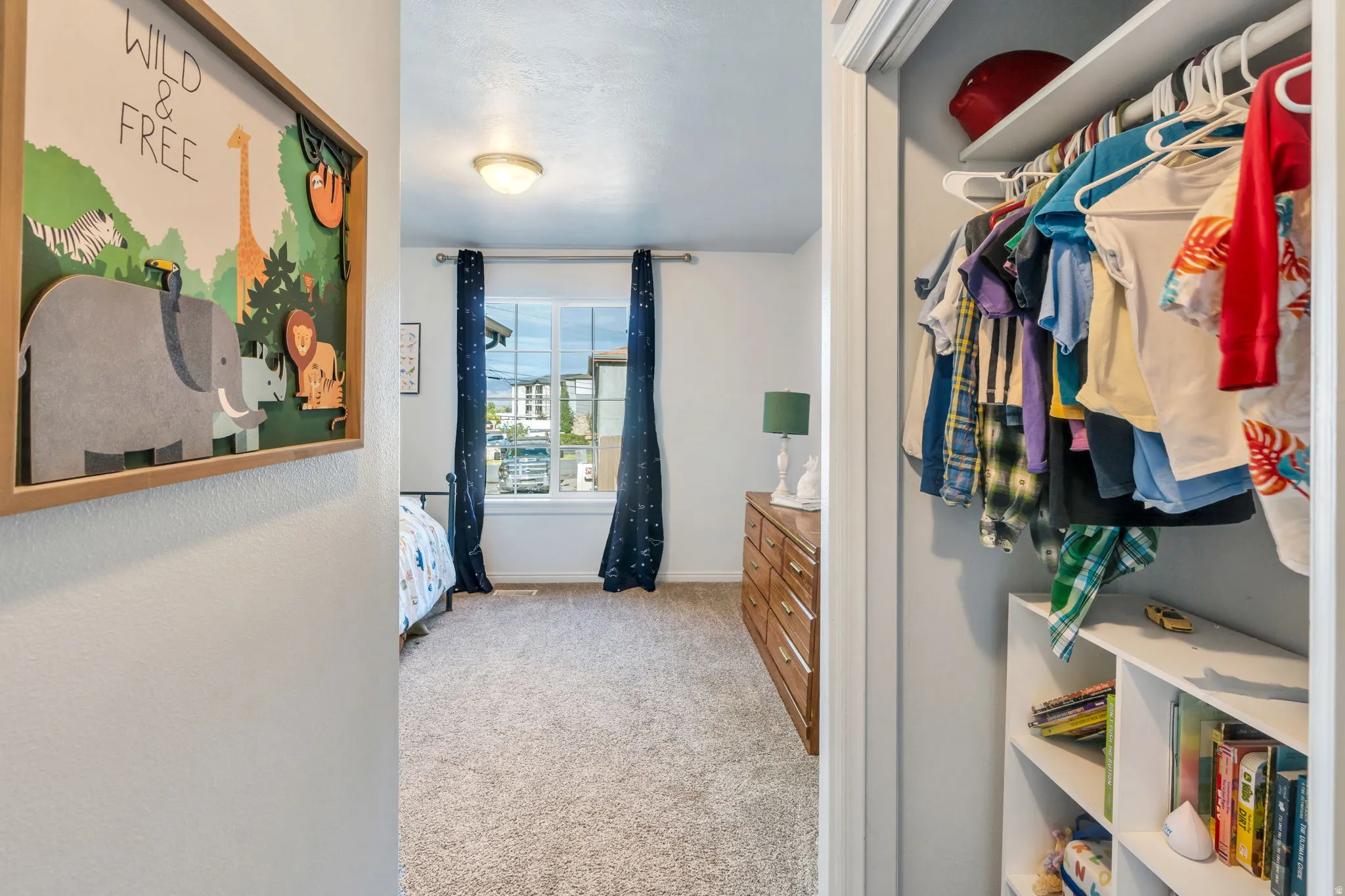 Bedroom featuring a single window with dark drapery, light carpeting, and a ceiling-mounted light fixture