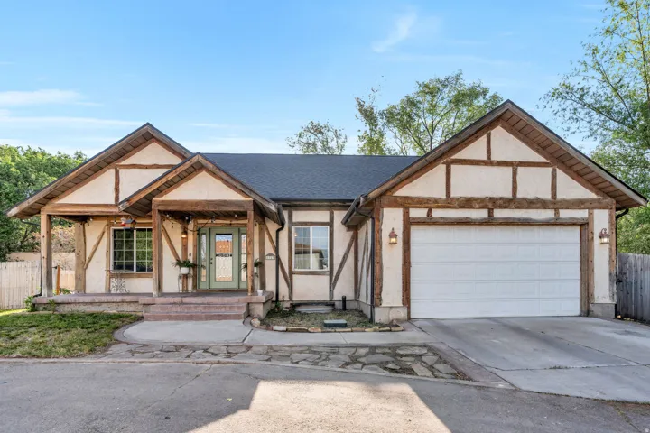 Tudor-style exterior featuring a prominent two-car garage