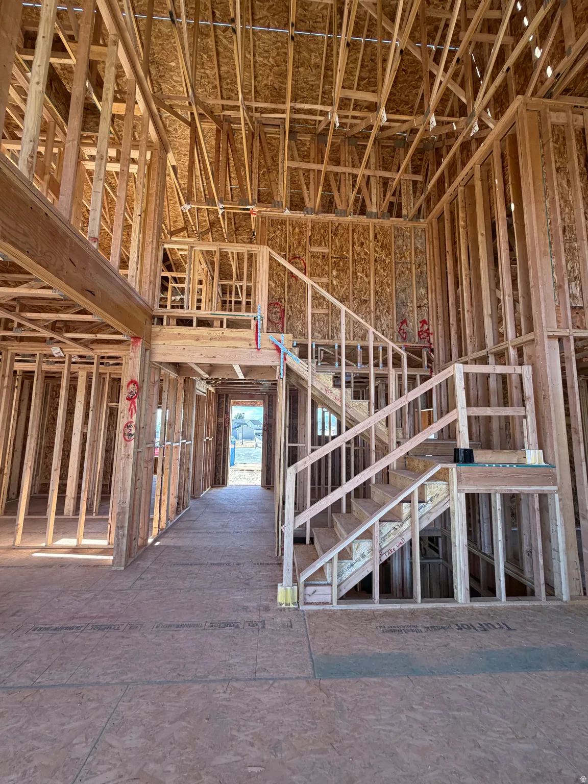 New construction framing featuring a multi-level layout and an open staircase