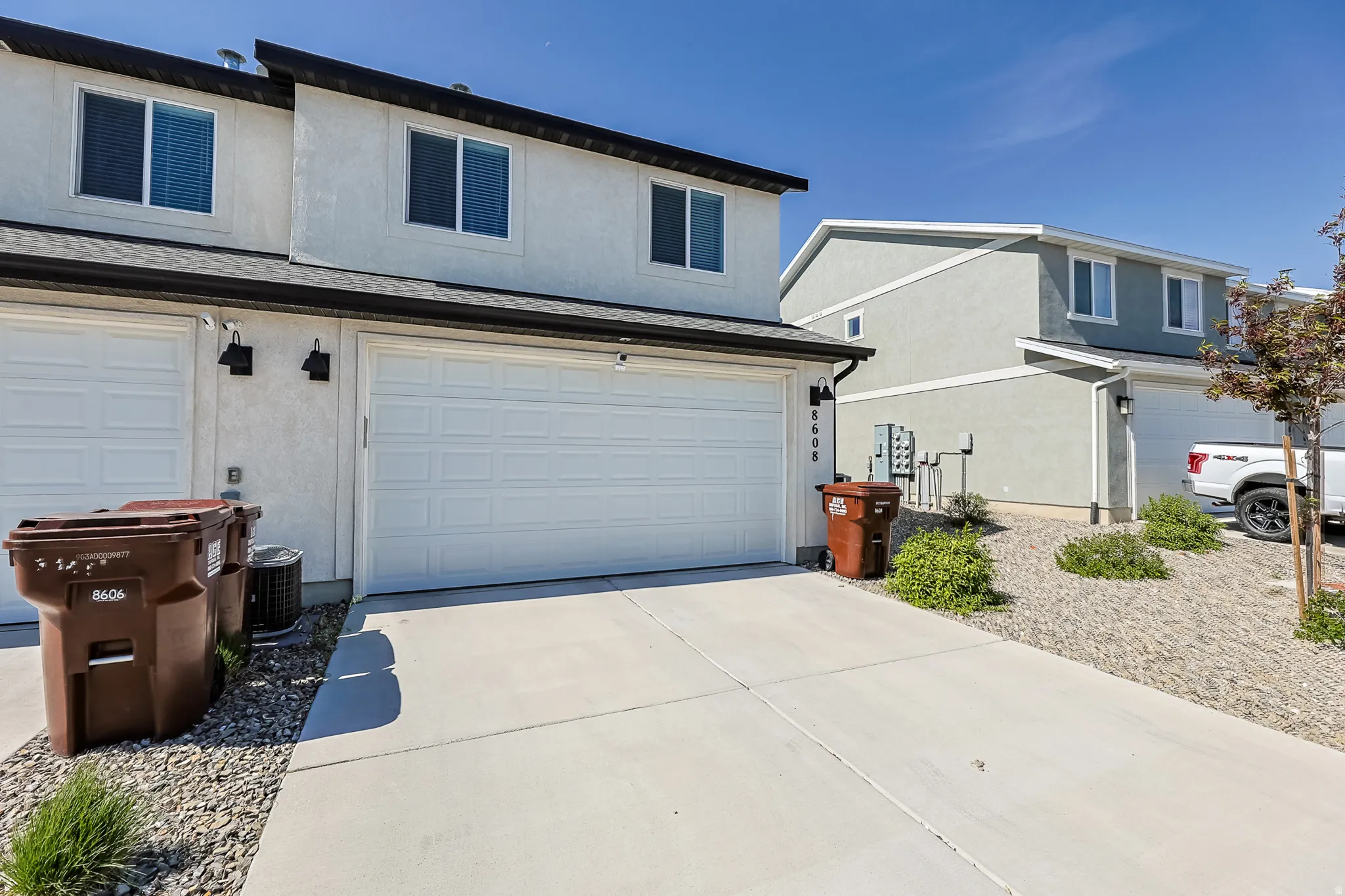 White stucco exterior with two garage doors