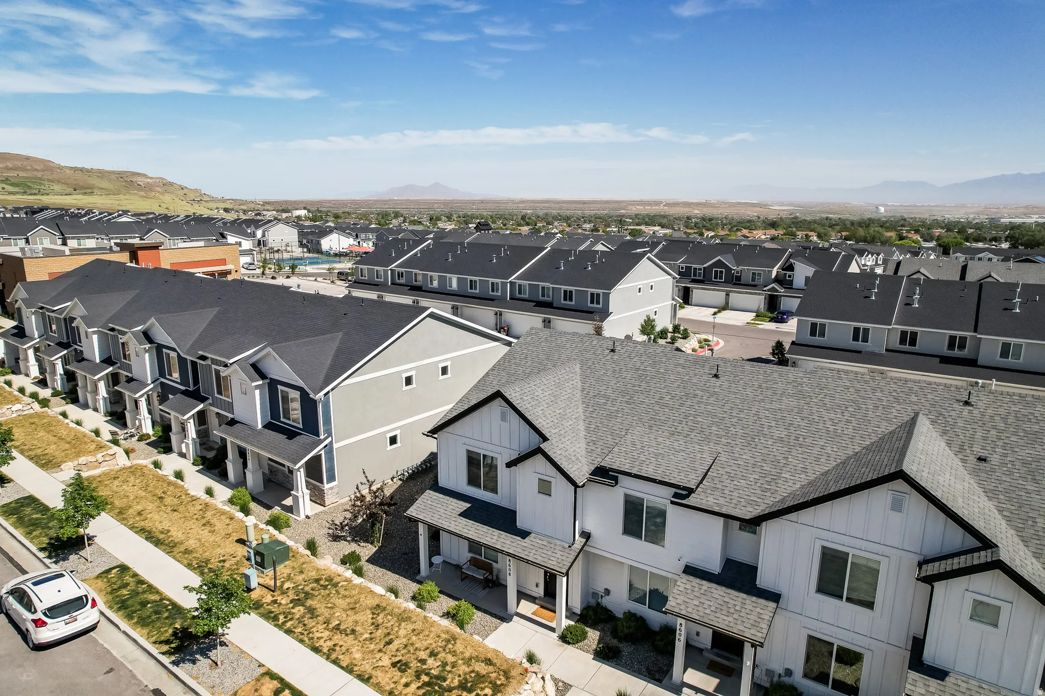 Contemporary townhome community featuring varied exterior finishes and pitched shingle roofs
