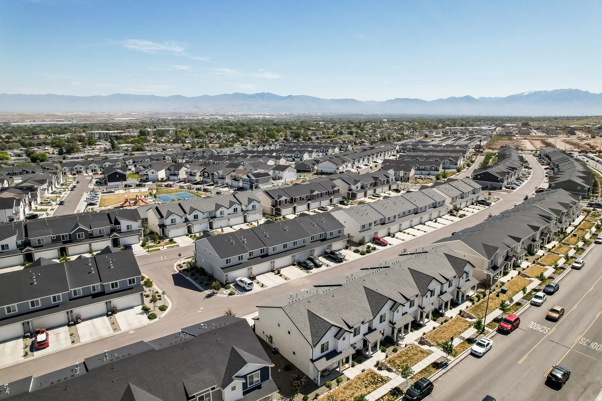 Expansive neighborhood featuring rows of modern townhomes with contrasting siding and dark roofs