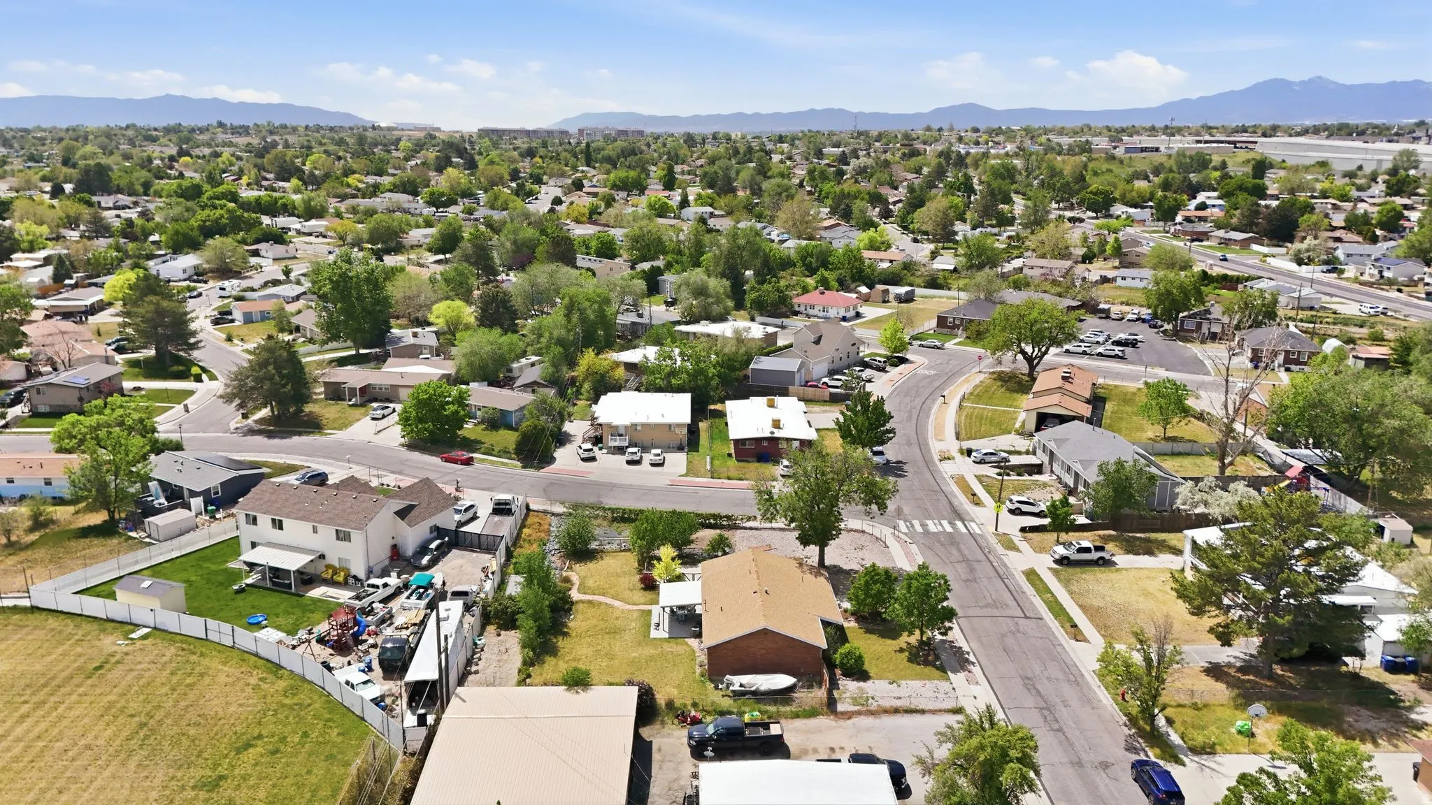 Aerial perspective of a residential neighborhood with a distant mountain range