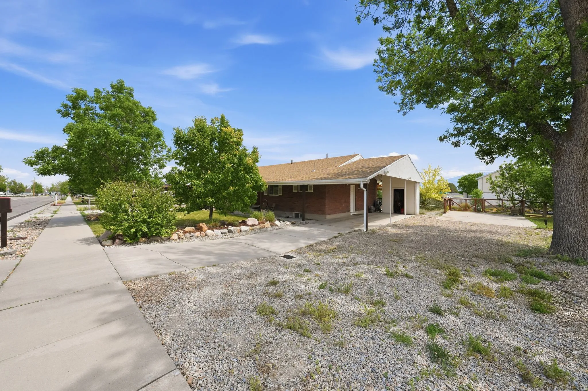 Ranch-style residence featuring a brick exterior and a covered carport
