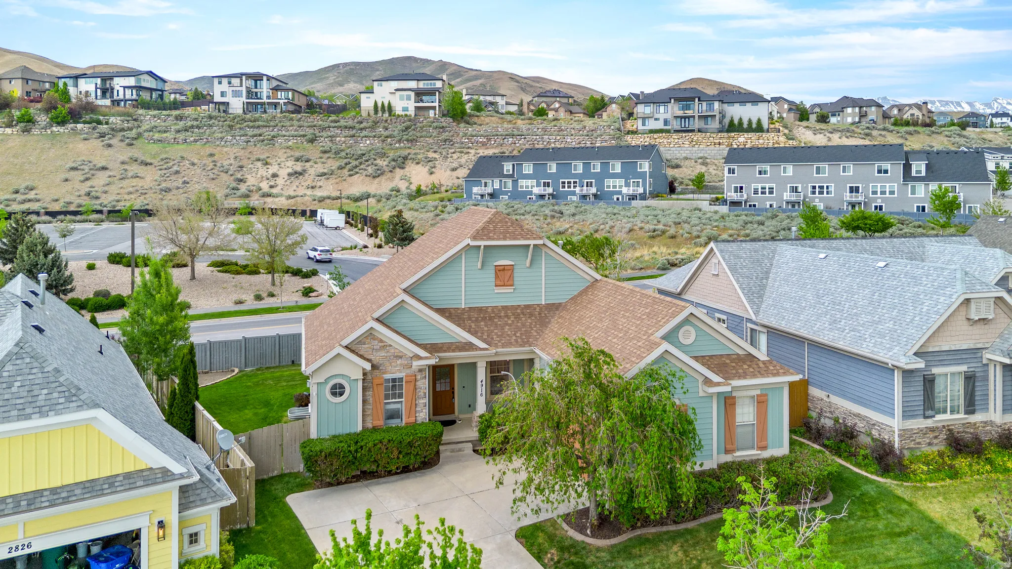 Craftsman-style residence with a combination of light blue siding and stone veneer