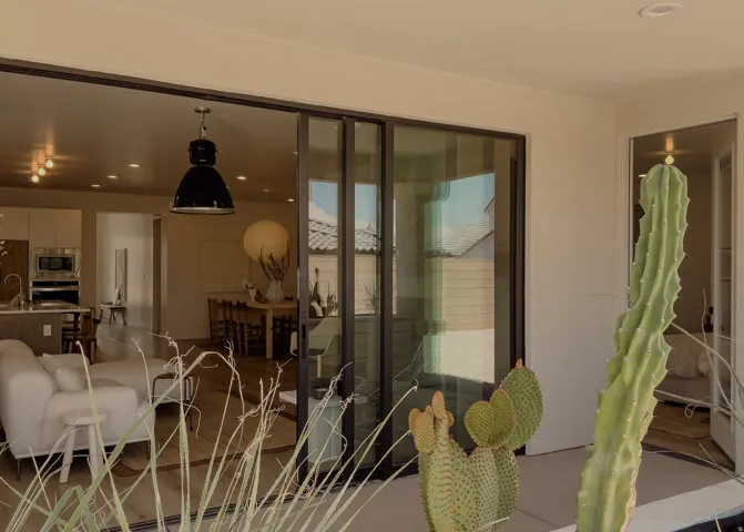 Expansive glass sliding doors open to an outdoor patio area