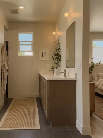 Double vanity with stone-finish countertop, dual sinks, and brushed nickel faucets
