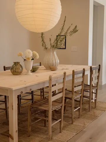 Dining area featuring a paper lantern light fixture, wood-finish flooring, and light-toned walls