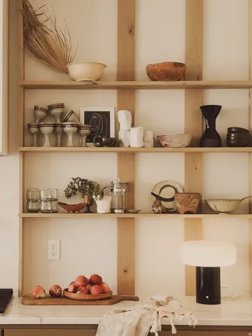 Built-in open shelving with natural wood framing