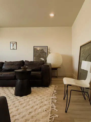 Recessed ceiling lighting illuminates light-toned walls and wood-finish flooring