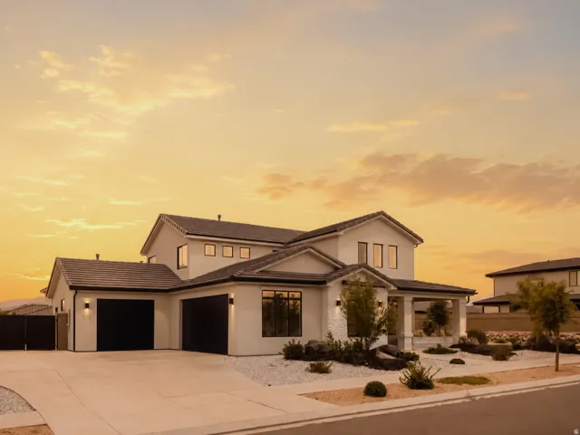 Contemporary two-story residence featuring a smooth stucco exterior and a dark tiled roof