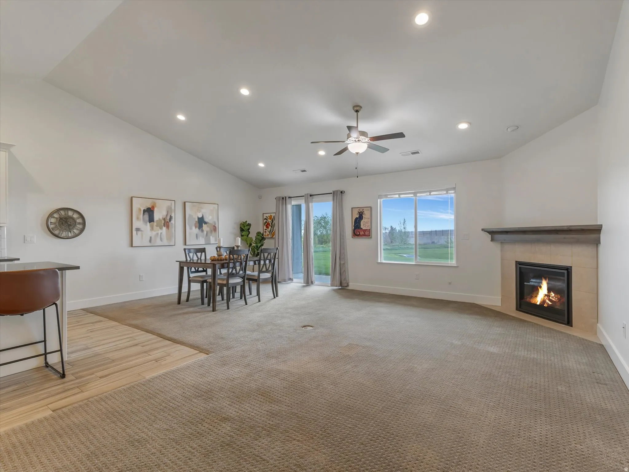 Spacious living area featuring a vaulted ceiling with recessed lighting and a ceiling fan