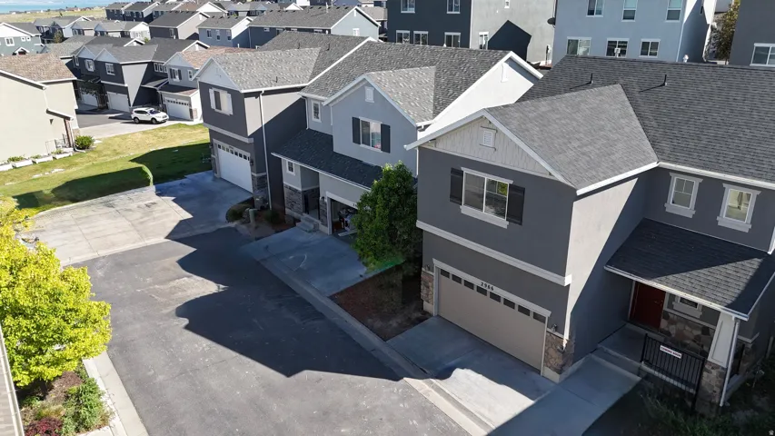 Contemporary two-story residence featuring a dark gray stucco exterior with white trim accents and a dark gray shingle roof