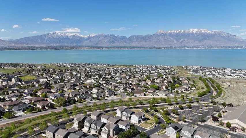 Expansive residential area with a prominent body of water and snow-capped mountains in the background