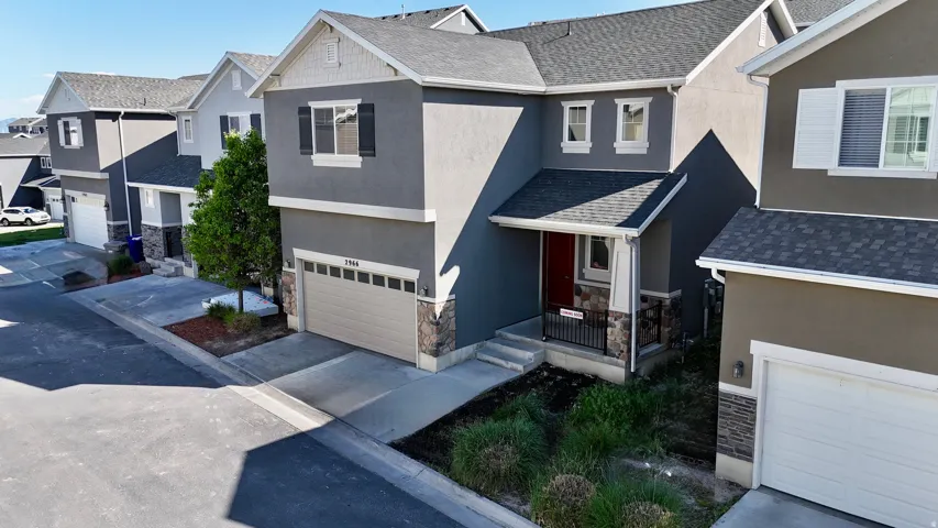 Contemporary exterior featuring gray stucco siding and stone accents
